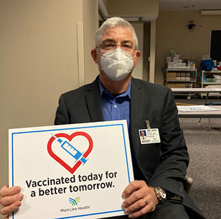 Dr Picchioni with vaccination sign
